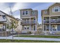 Charming two-story home with balconies, well-maintained lawn, picket fence, and inviting curb appeal at 128 E Douglas St, Superior, CO 80027