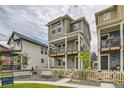 Charming three-story home featuring a welcoming porch and well-maintained yard with a cozy seating area and fence at 128 E Douglas St, Superior, CO 80027