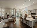 Open concept living space with modern fireplace, lots of natural light, and hardwood floors at 27110 E Fremont Pl, Aurora, CO 80016