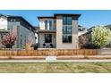 Charming two-story home with stone and gray accents, complemented by a well-maintained lawn at 6054 N Perth St, Aurora, CO 80019
