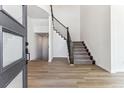 Bright entryway with hardwood floors and a modern staircase at 4993 Hickory Oaks St, Castle Rock, CO 80104