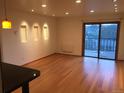 An interior shot of a vacant living room with hardwood floors and recessed lighting at 31270 John Wallace Rd # 310, Evergreen, CO 80439