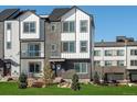 Modern three-story townhome with a front yard at 14411 Pansy Loop, Morrison, CO 80465