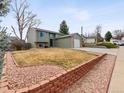 Charming two-story home with attached garage, a well-kept lawn, and red rock landscaping accents at 4182 S Bahama St, Aurora, CO 80013
