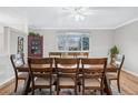 Dining room with wood table, chairs, and large window at 7636 S Eaton Way, Littleton, CO 80128