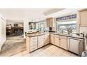 Bright kitchen featuring an island and modern appliances, adjacent to the breakfast nook and living room at 5938 E Weaver Cir, Centennial, CO 80111