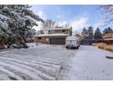 Two-story home featuring brick and brown siding, an attached garage, and a spacious driveway at 7835 Nelson St, Arvada, CO 80005