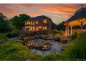 Picturesque backyard oasis featuring a serene pond with water lilies and a charming gazebo at 7472 S Utica St, Littleton, CO 80128