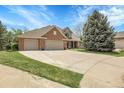 Charming home with a three-car garage, landscaped yard, and basketball hoop on the driveway at 7472 S Utica St, Littleton, CO 80128