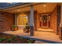 Inviting front porch featuring a brick facade, charming planters, and a welcoming entrance at 7472 S Utica St, Littleton, CO 80128
