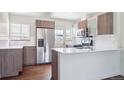 Renovated kitchen boasts stainless steel appliances, white countertops, and modern cabinetry at 4233 Shoshone St, Denver, CO 80211