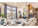 Spacious living room with a fireplace, large windows, and comfortable seating at 8159 Lodgepole Trl, Lone Tree, CO 80124