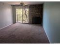Cozy living room with a fireplace and access to balcony at 431 S Kalispell Way # 308, Aurora, CO 80017