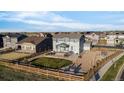 Expansive backyard features a patio, fire pit, green space, and wooden fence in a suburban neighborhood at 1845 Meagan Way, Erie, CO 80516