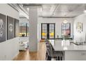 Spacious living room with concrete ceilings and access to a patio at 1499 Blake St # 3M, Denver, CO 80202