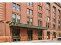 Street-level view of the Ice House entrance, featuring an industrial-style awning and showcasing the building's historic facade at 1801 Wynkoop St # 208, Denver, CO 80202