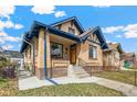 Attractive brick home featuring blue accents and a welcoming front porch at 2663 King St, Denver, CO 80211