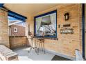 Cozy front porch with seating area and charming architectural details at 2663 King St, Denver, CO 80211