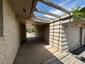 Entrance to the garage with open beam design and view of the front yard at 6040 W Elmhurst Dr, Littleton, CO 80128