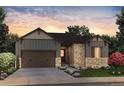 Charming home featuring a stone and siding exterior, lush landscaping, and a two-car garage at 8555 Hotchkiss St, Littleton, CO 80125