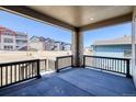 Covered patio with a dark stained railing offering community views on a sunny day at 8555 Hotchkiss St, Littleton, CO 80125