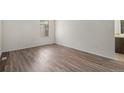 Neutral bedroom with hardwood-style floors and a bright window at 2832 S Mobile St, Aurora, CO 80013