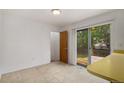 Bright dining area with sliding glass door leading to a deck and backyard at 2832 S Mobile St, Aurora, CO 80013