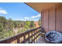 Relaxing balcony view with chair, table, and picturesque mountain scenery at 30819 Hilltop Dr, Evergreen, CO 80439