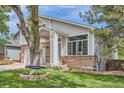 The home's exterior features a swing, brick accents, and meticulously maintained landscaping for a touch of natural beauty at 5260 Morning Glory Pl, Highlands Ranch, CO 80130