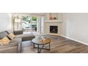 Comfortable living room featuring a fireplace and access to outdoor space at 9692 W Coco Cir # 103, Littleton, CO 80128