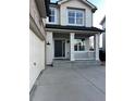 Inviting covered front porch featuring white columns and railings, perfect for enjoying the outdoors at 3231 Lump Gulch Way, Erie, CO 80516