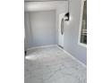 Inviting entryway featuring neutral walls and sleek marble tile flooring with a modern light fixture at 2619 S Bannock St, Denver, CO 80223