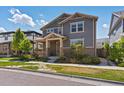 Inviting two-story home with covered porch, manicured lawn, and stone pathway in a friendly neighborhood at 5439 Verbena St, Denver, CO 80238