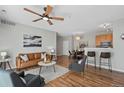 Bright and airy living room featuring hardwood floors and a leather sofa at 14343 E 1St Dr # 202, Aurora, CO 80011