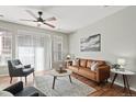 Cozy living room with hardwood floors, a leather sofa, and a large window at 14343 E 1St Dr # 202, Aurora, CO 80011