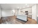 Open-concept kitchen with a center island, stainless steel appliances, and plenty of space at 18998 E 94Th Pl, Commerce City, CO 80022
