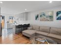 Open concept kitchen with island, stainless steel appliances, and stylish backsplash at 1085 N Wolff St, Denver, CO 80204