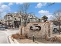 Community entrance sign, featuring brick construction, community name 'Topaz at Indian Creek', and well-maintained landscaping at 1885 S Quebec Way # C15, Denver, CO 80231