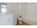 Well-lit bathroom with a white vanity, modern fixtures, and a shower-tub combination at 4975 Hickory Oaks St, Castle Rock, CO 80104