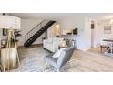 Stylish living area with wood floors, staircase, breakfast bar and modern decor at 10001 E Evans Ave # 74C, Aurora, CO 80247