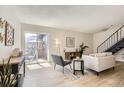 Bright living room with modern furnishings and a sliding glass door to the patio at 10001 E Evans Ave # 74C, Aurora, CO 80247