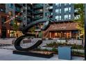 Attractive building entrance with modern sculpture, landscaping, and outdoor lighting at 20 Wilcox St # 309, Castle Rock, CO 80104