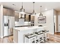 Modern kitchen with stainless steel appliances, white countertops, and pendant lighting at 20 Wilcox St # 309, Castle Rock, CO 80104