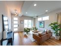Bright living room featuring wood floors, modern furniture, and a large window at 1355 Zenobia St, Denver, CO 80204