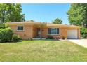 Lovely single-story brick home with a well-manicured lawn, long driveway and attached garage at 3354 W Arlington Ave, Littleton, CO 80123