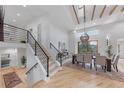 Bright entryway with wood stairs with iron railing, wood floors, and view to the dining room at 2857 Linden Dr, Boulder, CO 80304