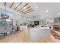 Bright open concept living with dining, living, and kitchen areas featuring a vaulted ceiling with skylights and wooden beams at 2857 Linden Dr, Boulder, CO 80304