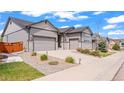 Well-maintained home showcasing a spacious driveway, a two-car garage, and tasteful landscaping at 7404 Greenwater Cir, Castle Rock, CO 80108