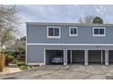 Exterior view of a multi-Gathering unit showing its carports and blue siding at 2557 S Dover St # 25, Lakewood, CO 80227