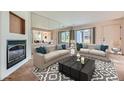 The living room features neutral-toned sofas, modern coffee table, and decorative fireplace at 2557 S Dover St # 25, Lakewood, CO 80227